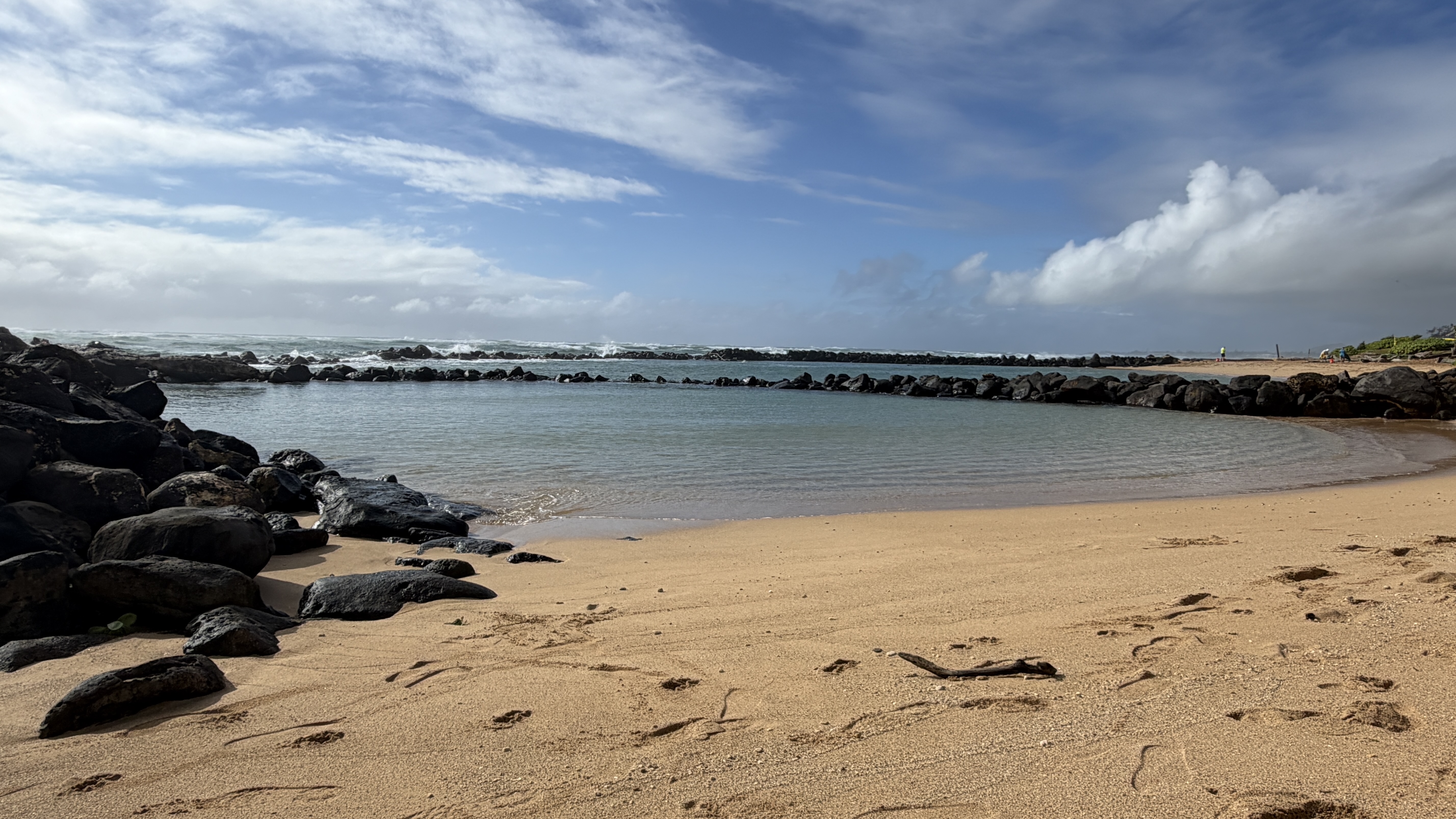 The sheltered saltwater pool and sandy shore at Lydgate Beach Park