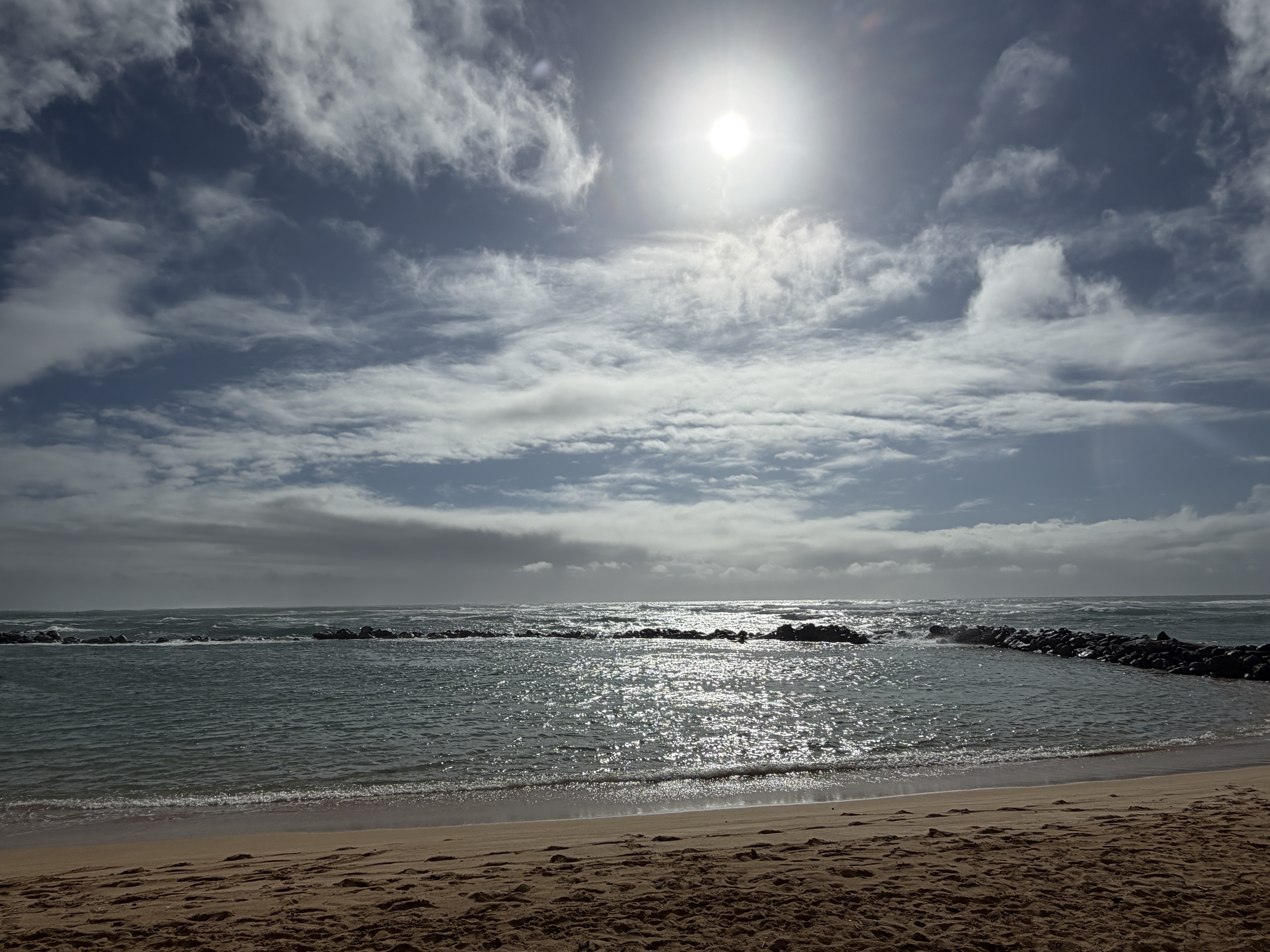 Sunlight over the protected ocean pool at Lydgate Beach Park